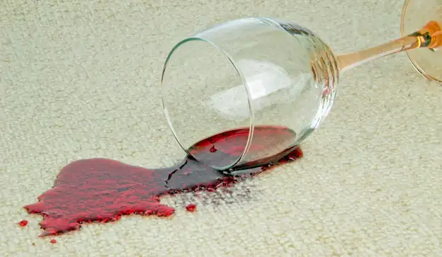 A fresh red wine spill on pale carpet