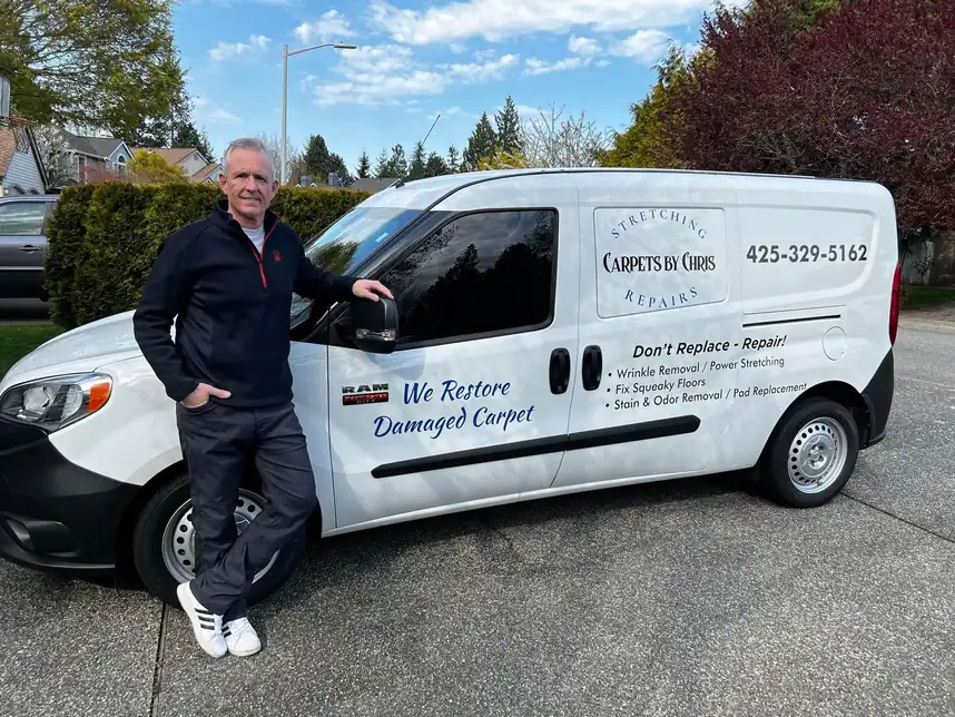 Chris Profitt standing beside the Carpets by Chris van outside a customer's home